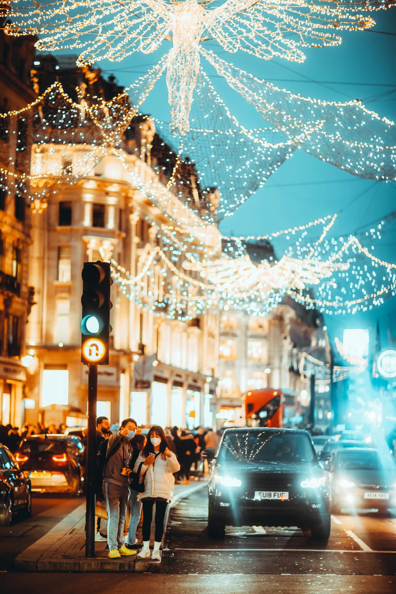 A busy crossing under Christmas lights in central London